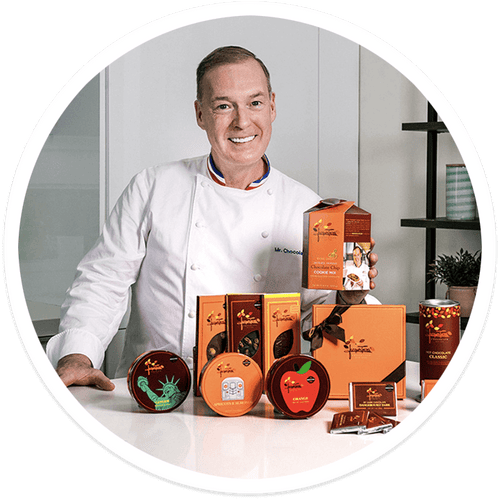 Chef Jacques Torres 幸运飞行艇官网开奖历史记录查询 with several of his products in a kitchen